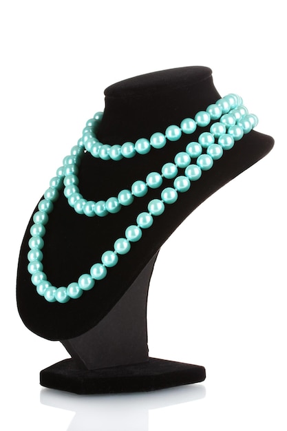 beautiful necklace of blue pearls on a mannequin isolated on white