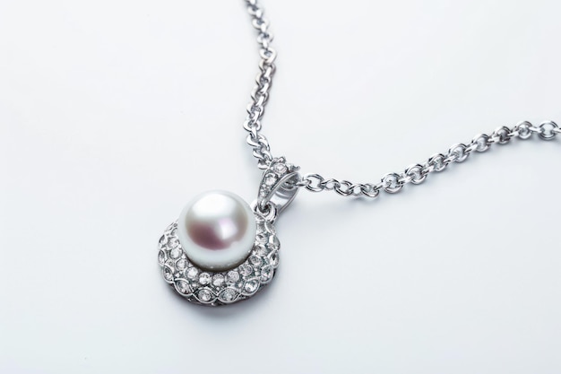 Photo beautiful necklace with a chain and a pendant with stones and a pearl on a white background
