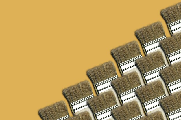 Photo beautiful new brush on a yellow creative background coppy space