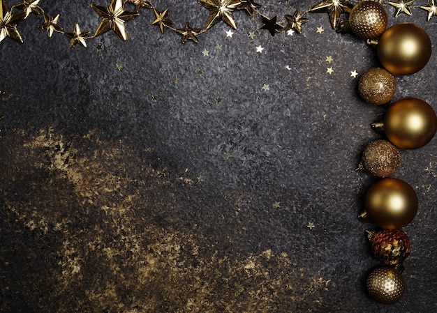 Beautiful new year dark background with gold christmas decorations and stars