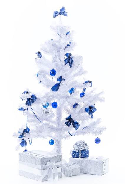 Beautiful New Year presents in silver blue color stand under the Christmas tree