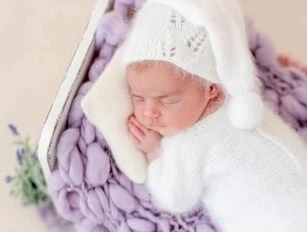 Beautiful newborn sleeping on tiny bed