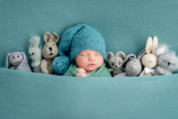 Beautiful newborn with knitted toys
