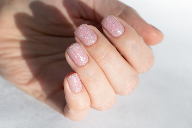 Beautiful nude manicure with a design on short square nails Manicure for women with gel polish