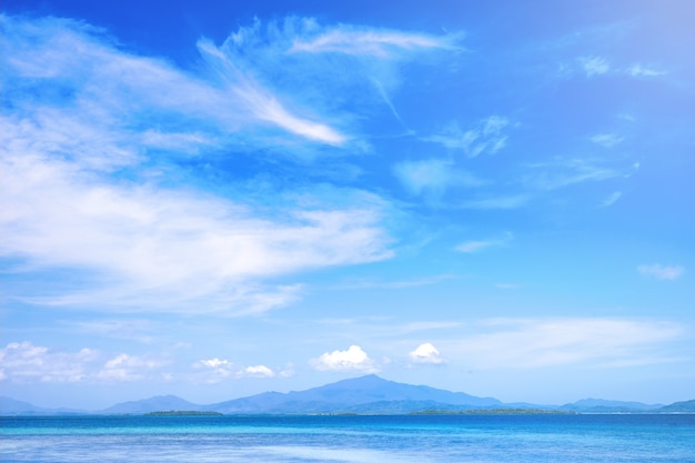 Beautiful ocean scene view isolated with light blue sky background