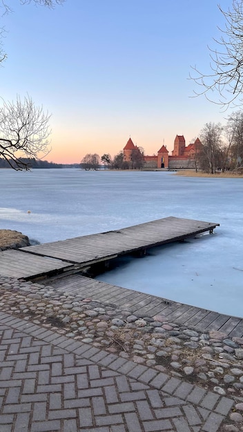 Beautiful old castle over a pond in ice