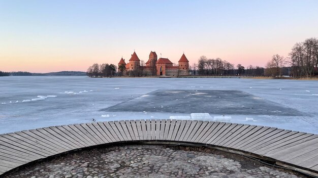 Beautiful old castle over a pond in ice