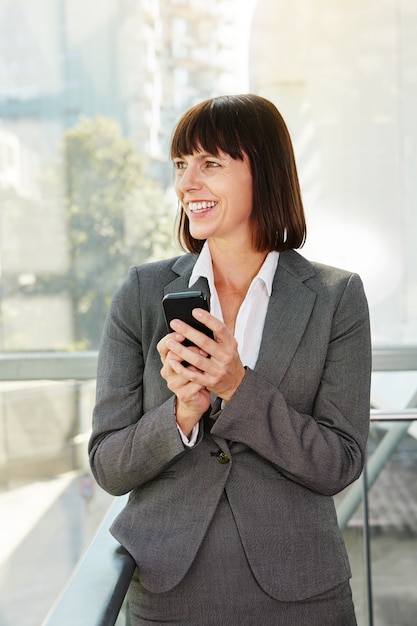 Beautiful older professional woman standing in city