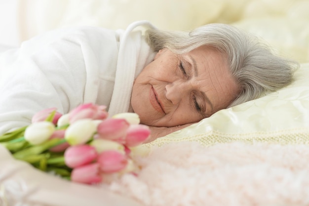 Beautiful older woman sleeping in the bedroom