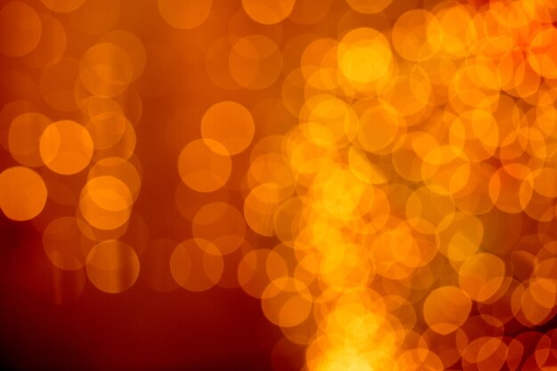 Beautiful orange golden blurred lights glitter on defocused background