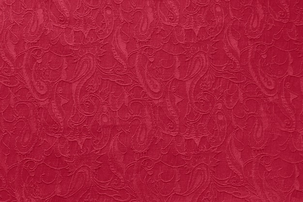 Beautiful ornate paisley ethnic fabric as background in trendy color 2023 Viva Magenta