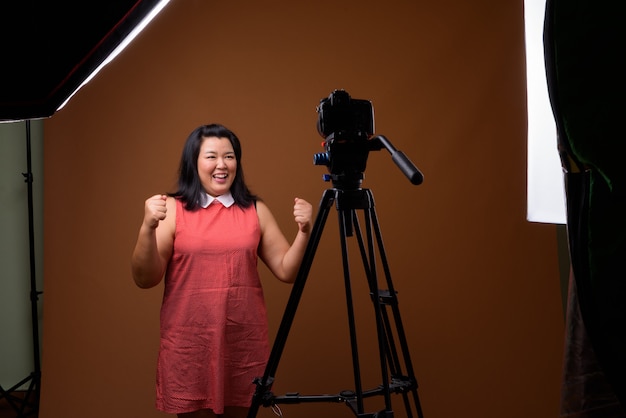 beautiful overweight Asian woman wearing red dress 