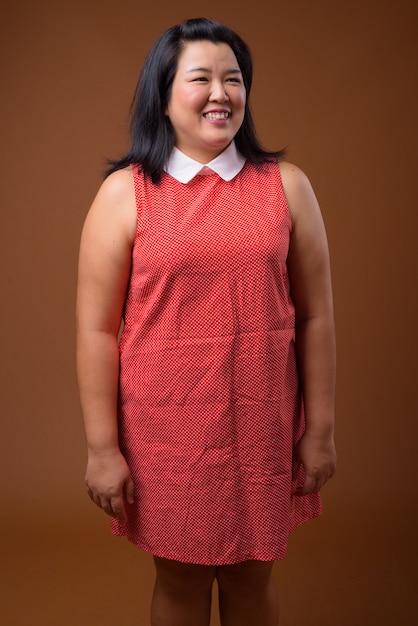 beautiful overweight Asian woman wearing red dress 