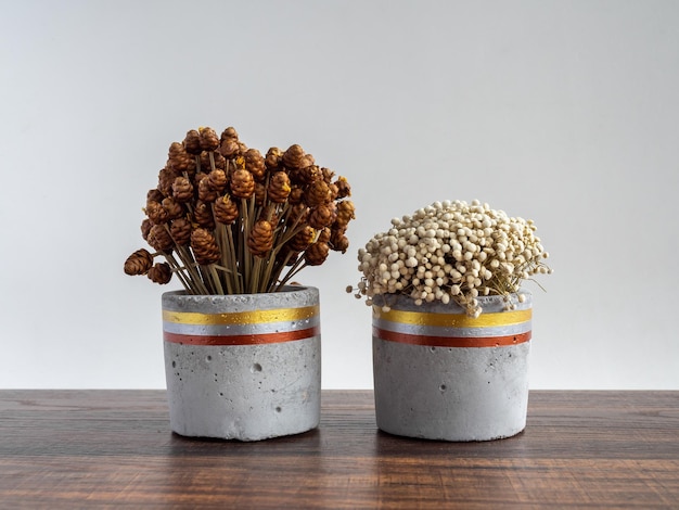 Beautiful painted concrete planter with dried flowers Handmade cement pot for home decoration