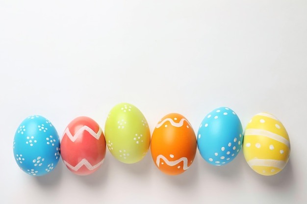 Beautiful painted Easter eggs on white background top view