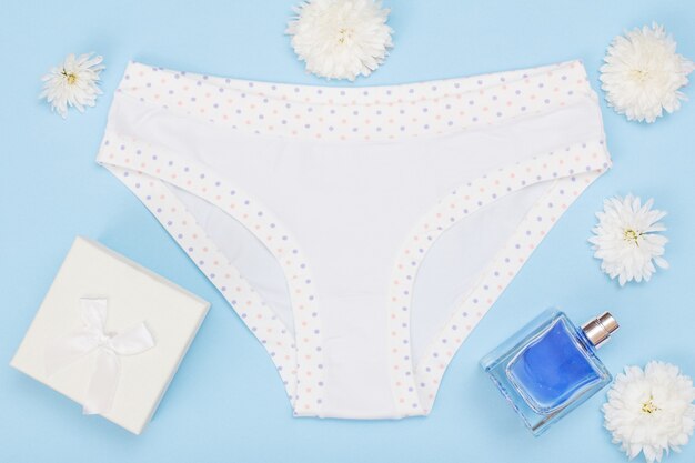 Premium Photo  Beautiful panties with bottle of perfume and gift box on  blue and white background. women sexy underwear set. romantic lingerie for  temptation. valentine's day concept.