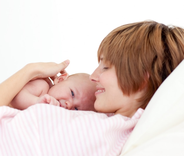 Beautiful patient with newborn baby in bed