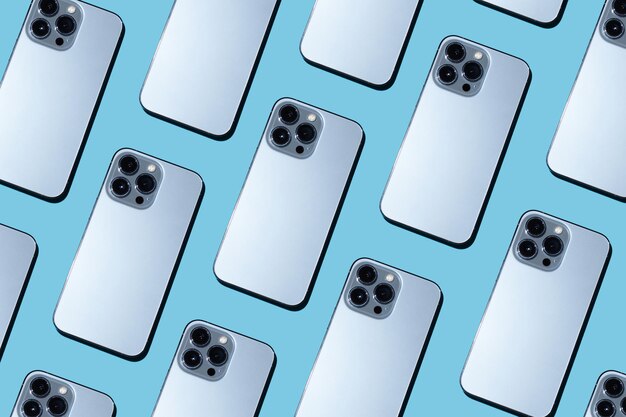 beautiful pattern with trendy phones on a blue background Phone cameras