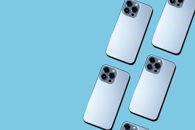 Beautiful pattern with trendy phones on a blue background Phone cameras