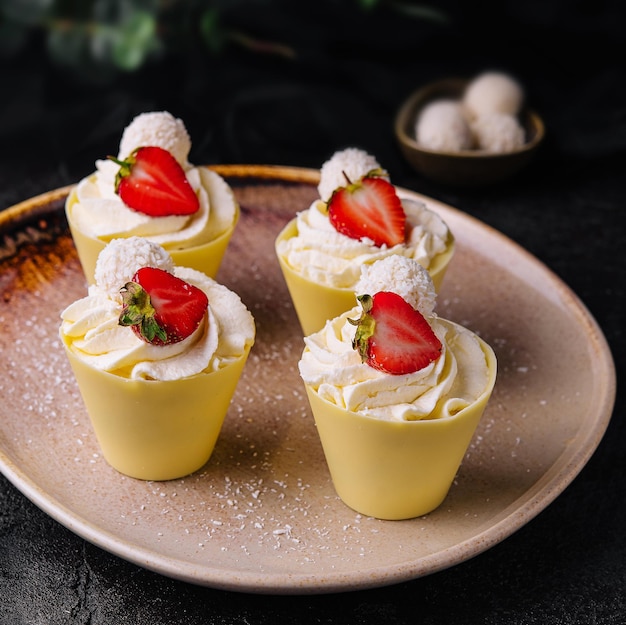 Beautiful pavlova cakes with strawberries and raffaello