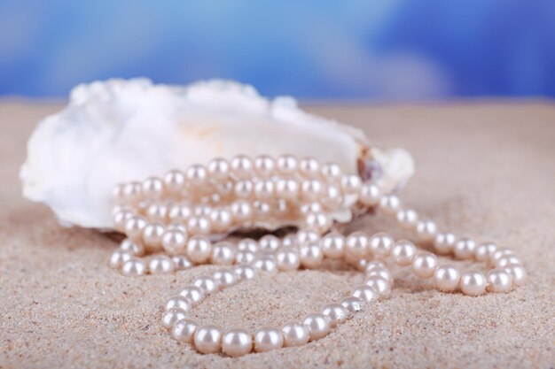 Beautiful pearls in shell on sand close up