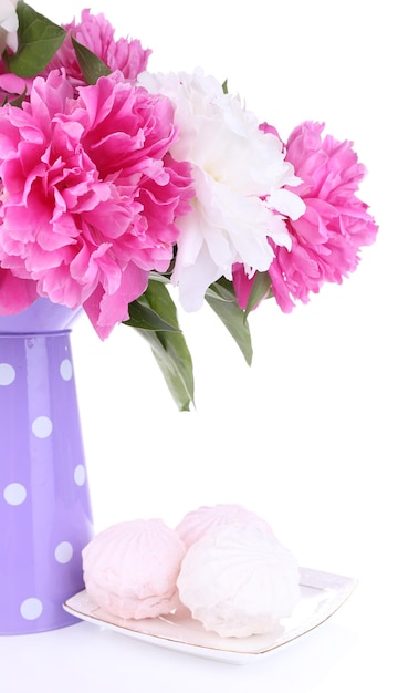 Beautiful peonies in vase and marshmallow, isolated on white