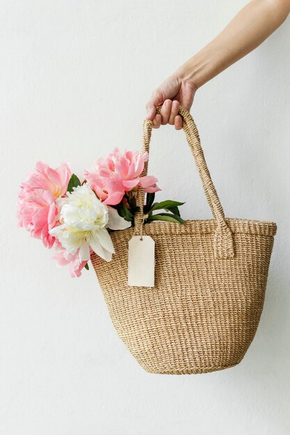 Beautiful peonies in a wicker bag