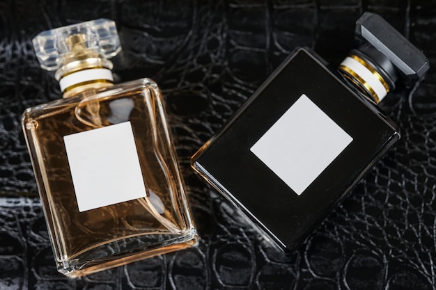 beautiful perfume bottle on black leather background