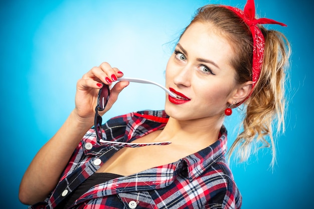 Beautiful pin up stylized young pregnant woman in kitchen drinking juice