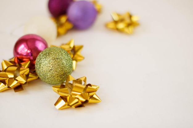 Beautiful pink Christmas baubles on white fur. Space for text