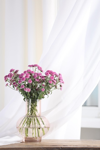 beautiful pink flowers in vase on table indoors space for text