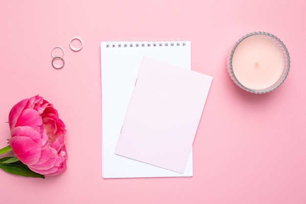 Beautiful pink peony flower and notebook