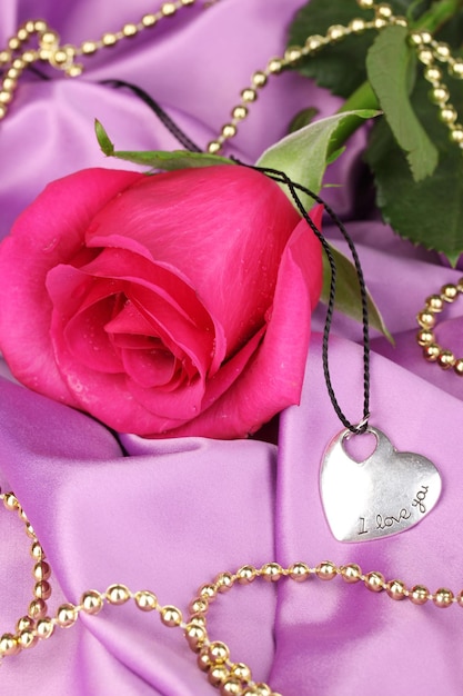 Beautiful pink rose with heart pendant