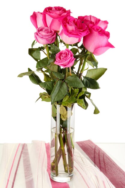 Beautiful pink roses in vase on table on white background