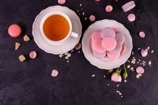 Beautiful pink tasty macaroons on a concrete background