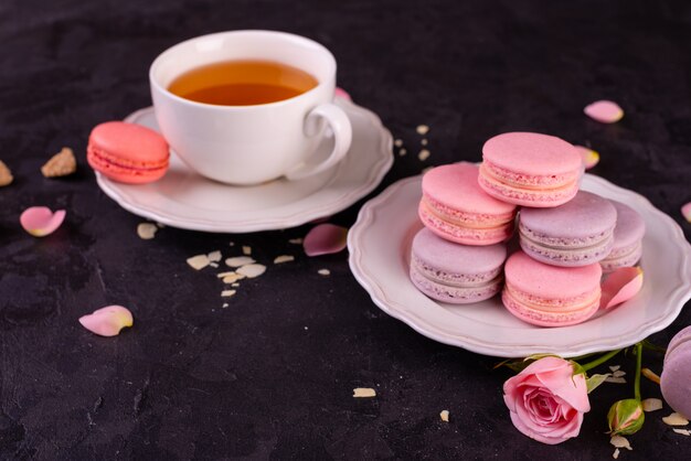 Beautiful pink tasty macaroons on a concrete background