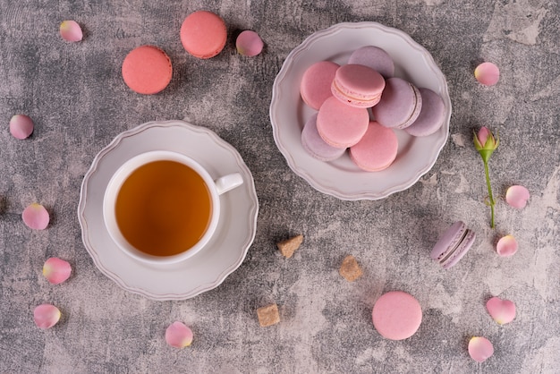 Beautiful pink tasty macaroons on a concrete background