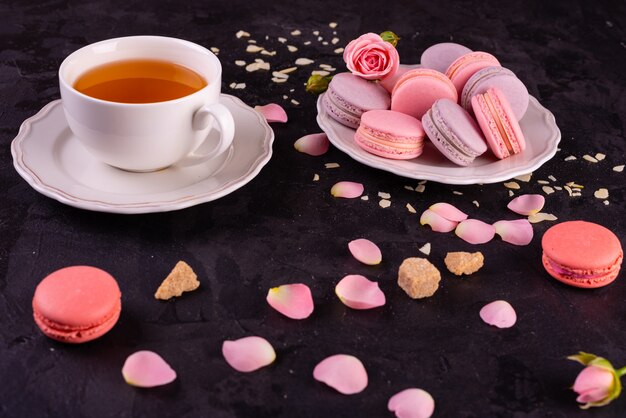 Beautiful pink tasty macaroons on a concrete background