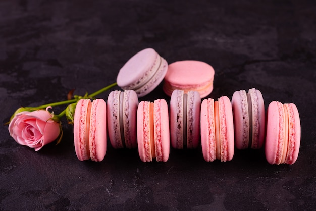 Beautiful pink tasty macaroons on a concrete background