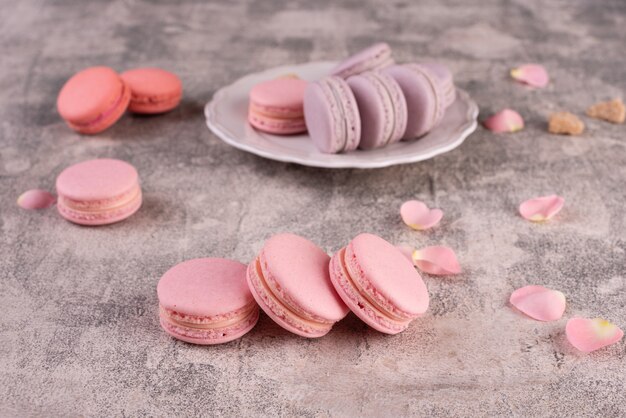 Beautiful pink tasty macaroons on a concrete background