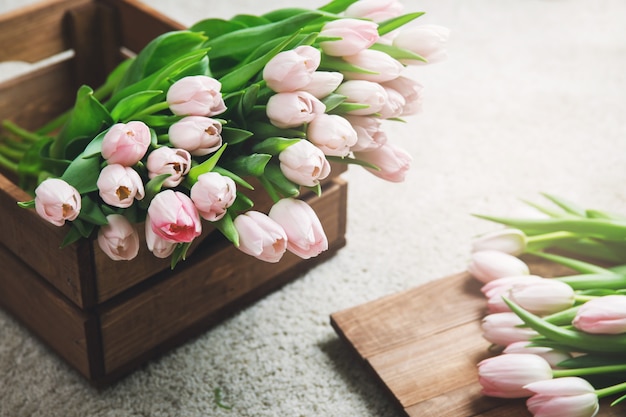 Beautiful pink tulip flowers in the wooden box