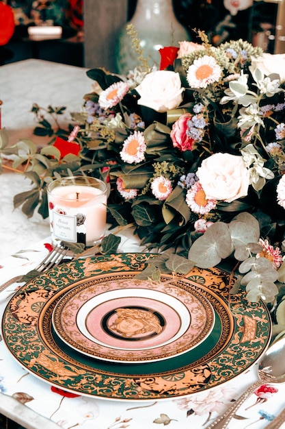 beautiful plate and fresh perfect colorful flowers standing on luxury table