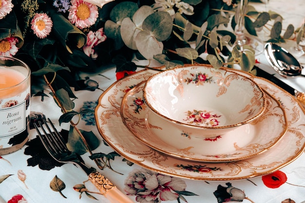 beautiful plate and fresh perfect colorful flowers standing on luxury table