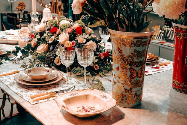 beautiful plate and fresh perfect colorful flowers standing on luxury table