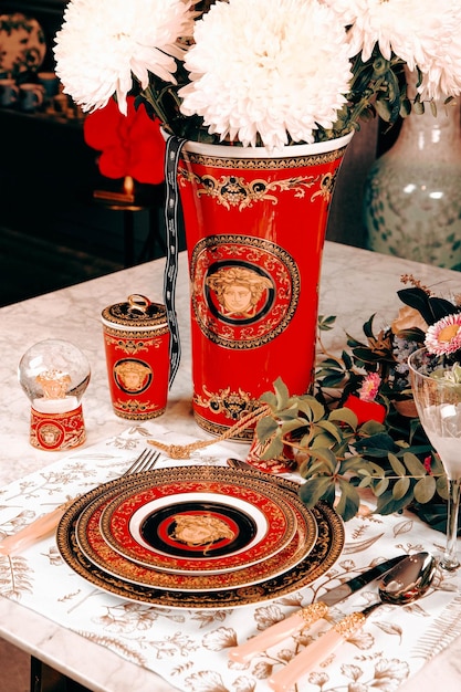 beautiful plate and fresh perfect colorful flowers standing on luxury table