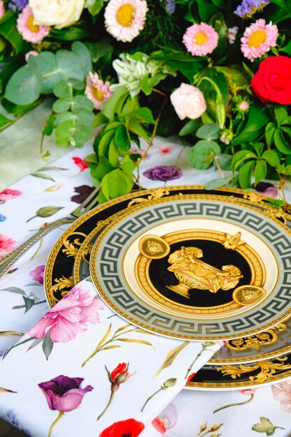 beautiful plate and fresh perfect colorful flowers standing on luxury table