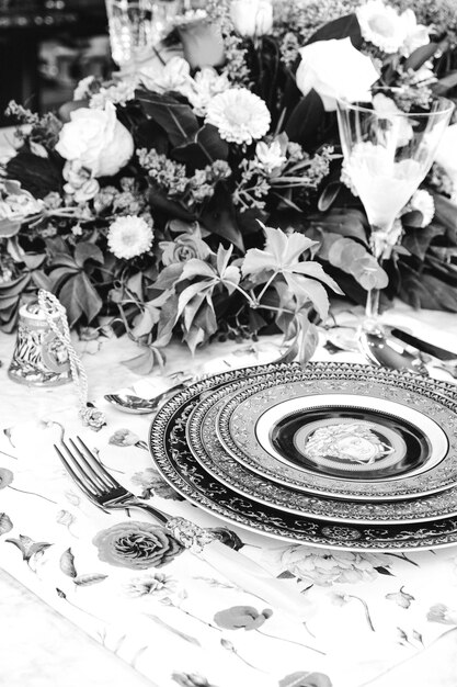 beautiful plate and fresh perfect colorful flowers standing on luxury table