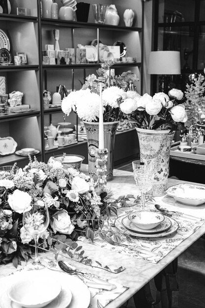 beautiful plate and fresh perfect colorful flowers standing on luxury table