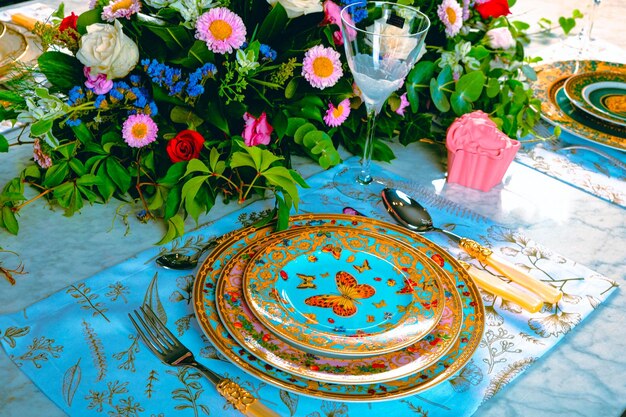 beautiful plate and fresh perfect colorful flowers standing on luxury table