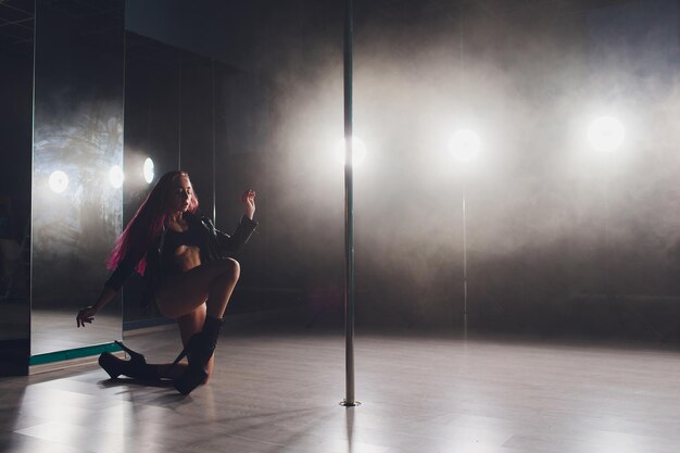 beautiful pole dancer in leather jacket on pylon